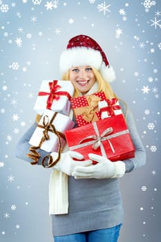 beautiful blonde woman holding a christmas gift is smiling