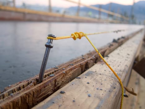 string line on a nail for concrete form work in construction close up