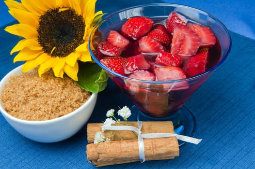 strawberries with red wine, cinnamon and brown sugar on a colore