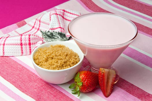 a  strawberry yogurt on a colored background