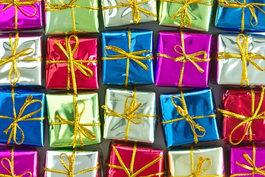 Background of many colorful glossy gift boxes