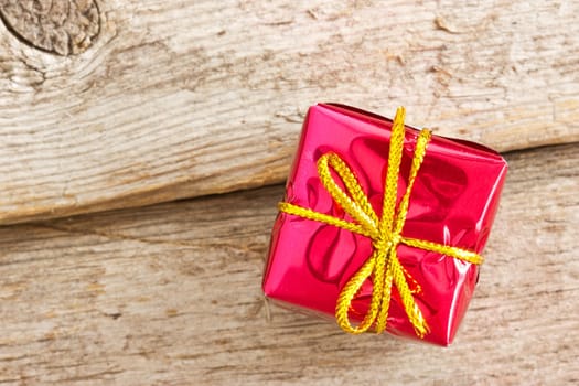 Red gift box on the old wooden floor