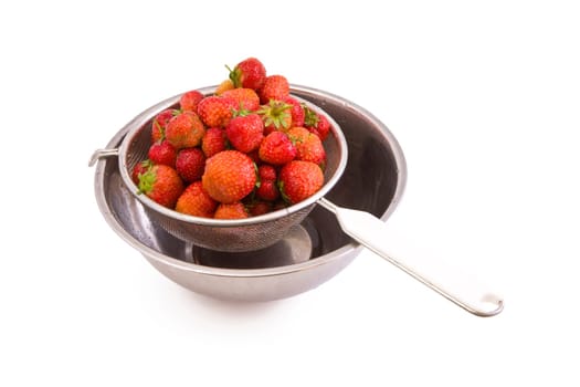 Fresh tasty strawberries in a colander isolated on white
