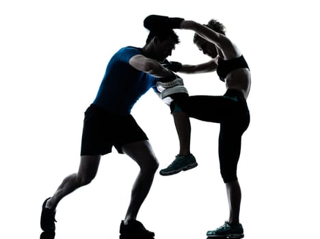 one caucasian couple man woman personal trainer coach man woman boxing training silhouette studio isolated on white background