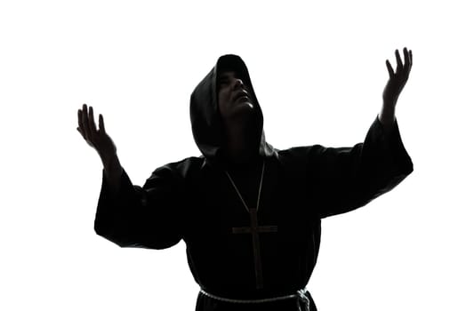 one caucasian man priest praying silhouette in studio isolated on white background