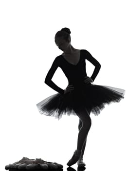 one caucasian young woman ballerina ballet dancer dancing with tutu in silhouette studio on white background