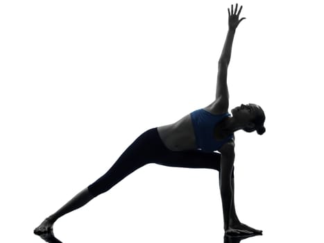 one caucasian woman exercising stretching triangle pose yoga in silhouette studio isolated on white background