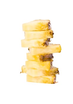 Ripe pineapple fruits slices in pile isolated on white