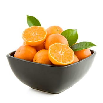 Fresh juicy tangerines in black bowl isolated on white background