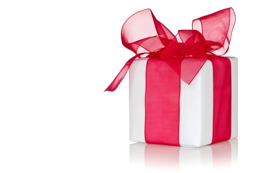 White gift box with red ribbon. Isolated on white background.