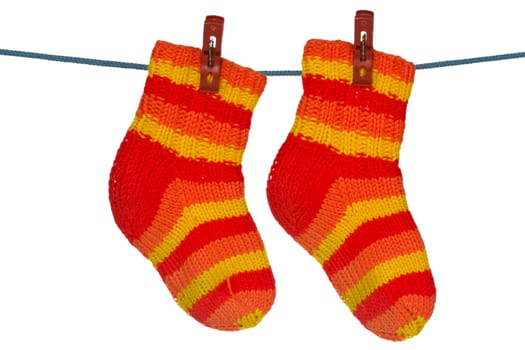 Knitted socks hung on the rope. Isolated over a white background