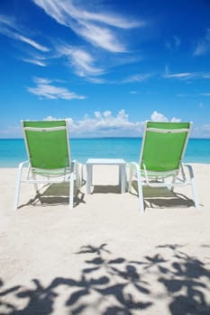 Two deckchairs on a beautiful beach