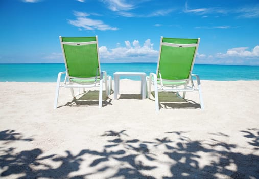Two deckchairs on a beautiful beach