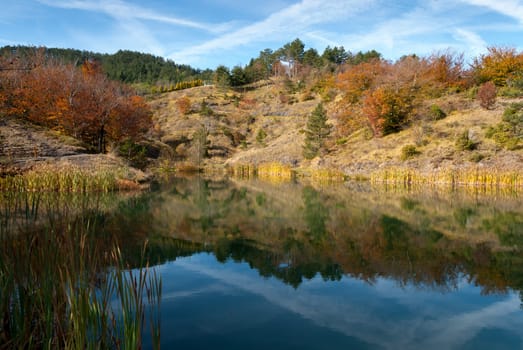 Bocco lake the woods with autumn colors in Liguria