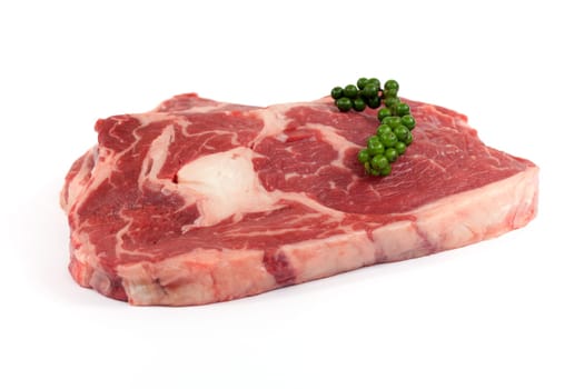 Rib eye steak,juicy raw meat against white background