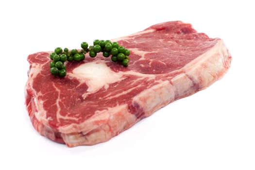 Rib eye steak,juicy raw meat against white background