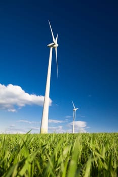 Windmills against a blue sky and clouds, alternative energy source
