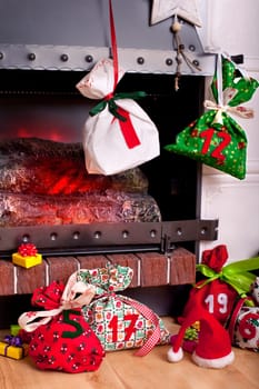 filled Advent calendar by the fireplace