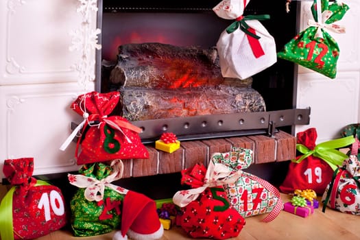 filled Advent calendar by the fireplace