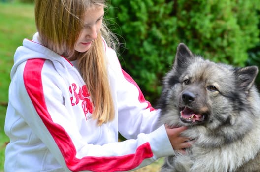 Girl with dog as a friend while playing