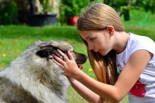 Girl with dog as a friend while playing