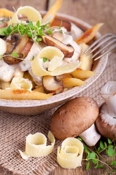 golden brown potato noodles with fresh champions