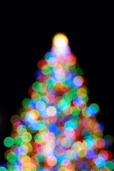 Christmas Tree with Colorful Out of Focus Blurred Light on Black Background