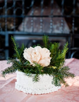 a centerpiece with pink and pine branches