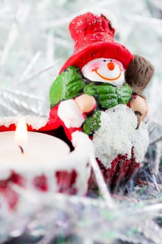A Christmas snowman candle with fire