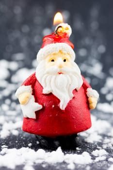 Santa Claus burning candle