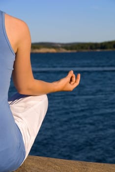 cutout of a woman doing yoga at the sea