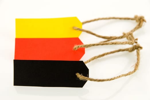 three labels, one in black, one in red and one in yellow, on white