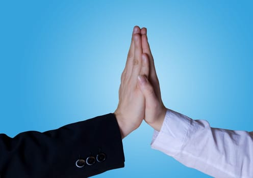 two business hands symbolizing success with blue background