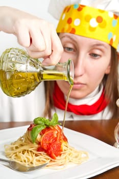 smiling chef garnish an Italian pasta dish