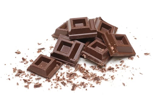 Chocolate squares and crumbles on white background