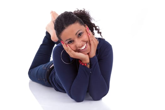 Portrait of a young African American woman lying down on the floor, isolated on white background