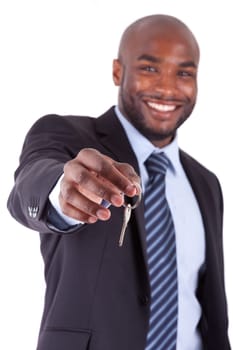 Young African American businessman holding a house key, isolated on white background