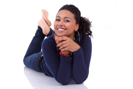 Portrait of a young African American woman lying down on the floor, isolated on white background