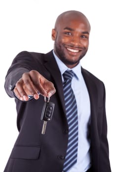 Young African American businessman holding a car key,isolated on white background