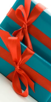 two blue presents with red ornamentation, isolated