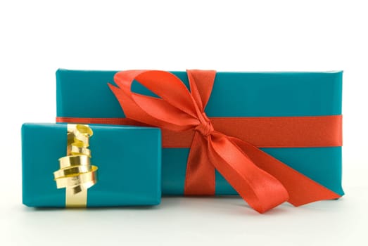 two birthday or christmas presents in blue with red and gold ornamentation, isolated on white