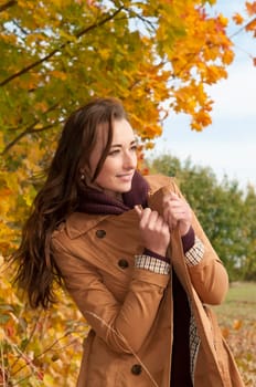 Happy young woman in autumnal park