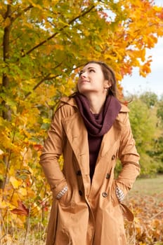 Happy young woman in autumnal park