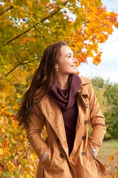 Happy young woman in autumnal park