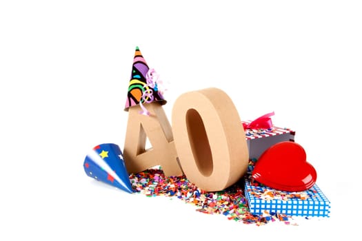 Number of age in a colorful studio setting with paper party hats, a red heart and gifts on a bottom of confettie