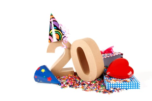 Number of age in a colorful studio setting with paper party hats, a red heart and gifts on a bottom of confettie