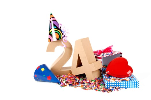 Number of age in a colorful studio setting with paper party hats, a red heart and gifts on a bottom of confettie