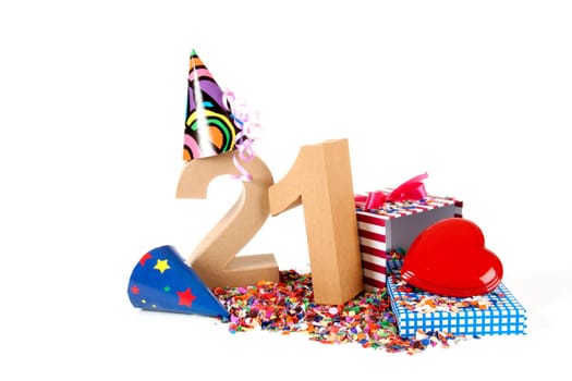 Number of age in a colorful studio setting with paper party hats, a red heart and gifts on a bottom of confettie