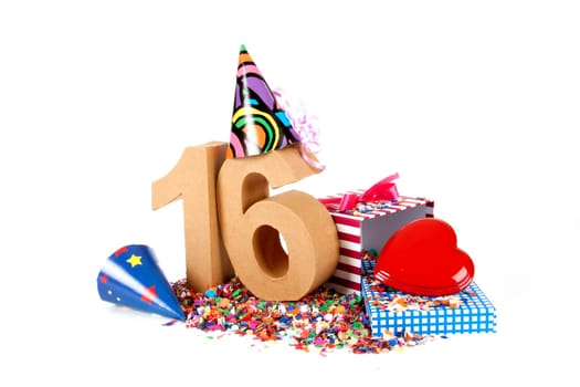 Number of age in a colorful studio setting with paper party hats, a red heart and gifts on a bottom of confettie