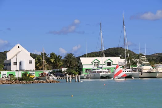 Wind surfer sailing in Falmouth Harbour Marina in Antigua Barbuda.